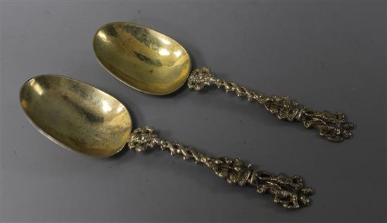 A pair 19th century continental silver gilt spoons with figural terminals, 17.6cm.